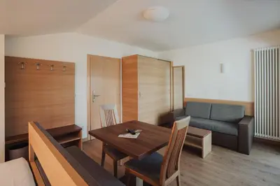 a living room with a table and a couch at Weihergut in Cermes