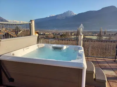 a jacuzzi tub on a balcony with a view at Weihergut in Cermes