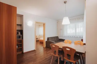 a dining room and living room with a table and chairs at Weihergut in Cermes
