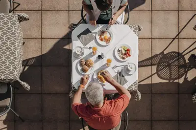 two people sitting at a table eating food at Weihergut in Cermes