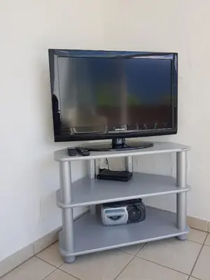 a flat screen tv on a white shelf at Appartementhaus Linter in Tirolo