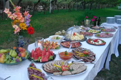 a table with many plates of food on it at Hotel Villnerhof in Egna