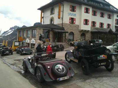 a group of antique cars parked in front of a building at Hotel Savoia in Canazei