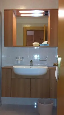 a bathroom with a sink and a mirror at Hotel Savoia in Canazei