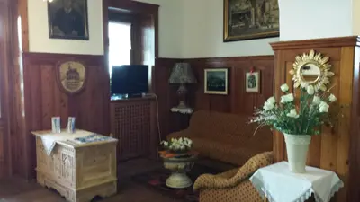 a living room with a couch and a table at Hotel Savoia in Canazei