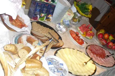 a table topped with lots of different types of bread at Dependance Villnerhof in Egna