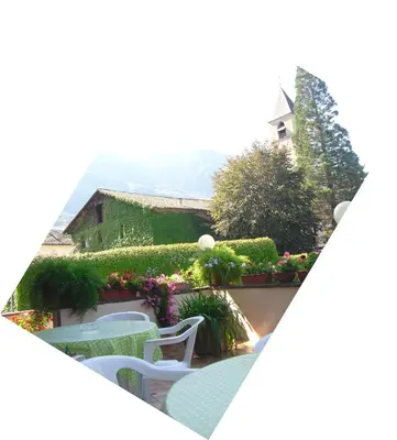 a view of a patio with a table and chairs at Dependance Villnerhof in Egna