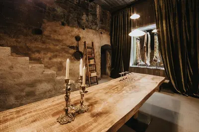 a sauna with wooden walls and benches in a room at Presulis Hideaway Apartments & Restaurant in Fiè