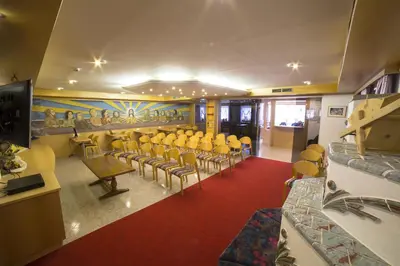 a conference room with chairs and a flat screen tv at B&B Garni Hotel Saxl in Campo di Trens