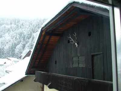 a building with a deer head on the side of it at Gasthof Obermair in Chienes