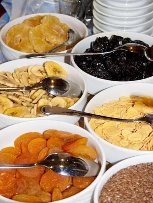 a table topped with bowls of different types of food at Hotel-Garni Appartement Gartenheim in Schenna