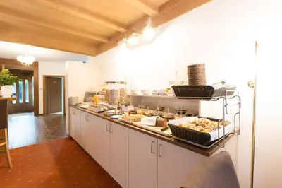 a kitchen with a buffet of food on a counter at Pension Sankt Urban in Merano