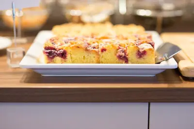 a blueberry cake on a plate on a table at Pension Sankt Urban in Merano