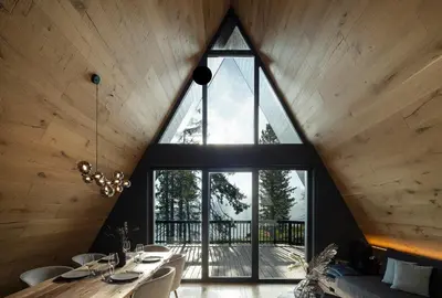 a large window in a room with a table and chairs at LUXE VISTA Mountain Chalet Cermis - mitten auf der Alm und Skipiste in Cavalese