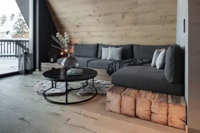 a living room with a couch and a table at LUXE VISTA Mountain Chalet Cermis - mitten auf der Alm und Skipiste in Cavalese