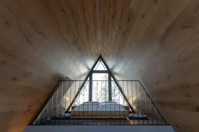 a room with a window on the top of a stairs at LUXE VISTA Mountain Chalet Cermis - mitten auf der Alm und Skipiste in Cavalese