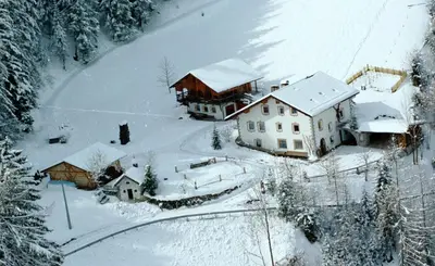 an aerial view of a house in the snow at Apartment Puciacia - Bauernhof in Santa Cristina in Val Gardena