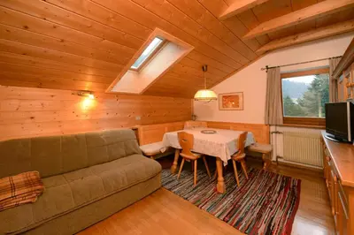 a living room with a couch and a table at Apartment Puciacia - Bauernhof in Santa Cristina in Val Gardena