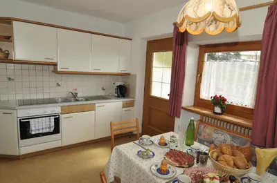 a kitchen with a table with food on it at Fiziderhof in Castelrotto