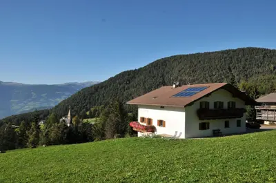 a house on a hill with a solar roof at Fiziderhof in Castelrotto