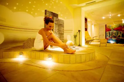 a woman sitting on the floor in a room at Aparthotel Kastel Seiser Alm in Castelrotto
