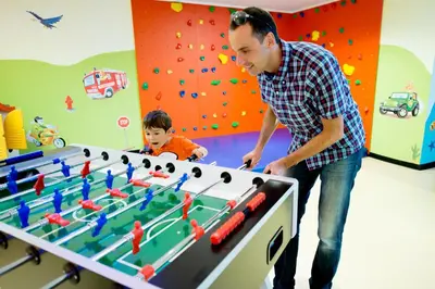 a man playing a game of foosball at Aparthotel Kastel Seiser Alm in Castelrotto