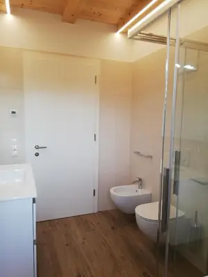 a bathroom with a toilet and a sink at Gisshübelhof in Andrian