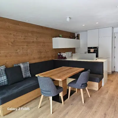 a living room with a couch and a wooden table at Sonnenparadies in San Genesio Atesino
