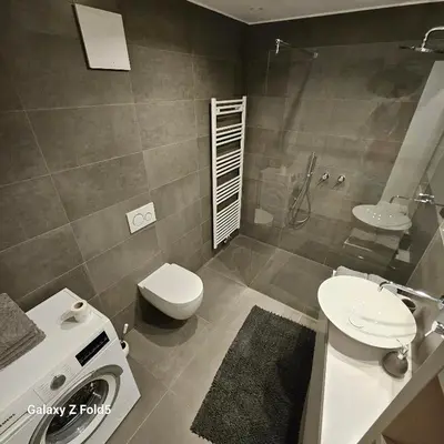 a bathroom with a toilet and a sink and a shower at Sonnenparadies in San Genesio Atesino