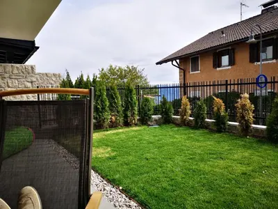 a backyard with a fence and a yard with green grass at Sonnenparadies in San Genesio Atesino