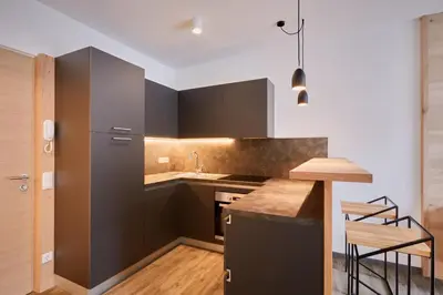 a kitchen with black cabinets and a counter top at Residence Laitacherhof - Modern Apartments with Sauna in Chiusa