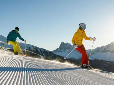 two people are skiing down a snow covered slope at Residence Laitacherhof - Modern Apartments with Sauna in Chiusa