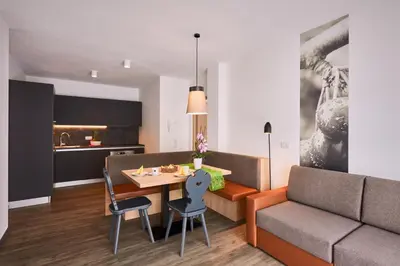 a living room with a table and a couch at Residence Laitacherhof - Modern Apartments with Sauna in Chiusa