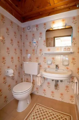 a bathroom with a toilet and a sink at Chalet Funtanacia in La Villa