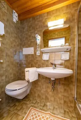 a bathroom with a sink and a toilet at Chalet Funtanacia in La Villa