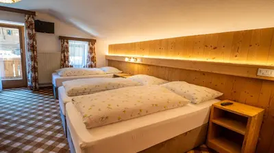 a room with three beds in a room at Chalet Funtanacia in La Villa