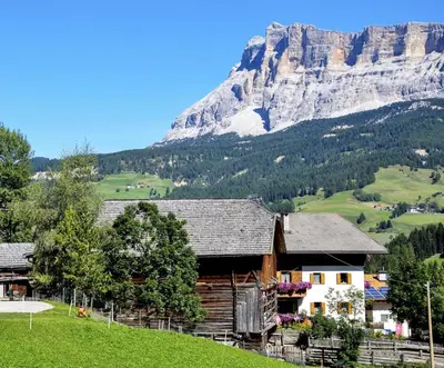 a house on a hill with a mountain in the background at Chalet Funtanacia in La Villa