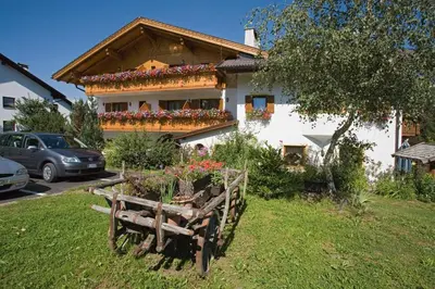 a house with flowers in the front of it at Hotel Thuinerwaldele in Vipiteno