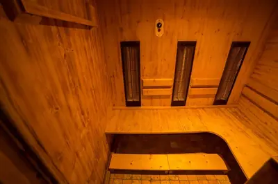 an empty room with wooden walls and a bench at Hotel Thuinerwaldele in Vipiteno