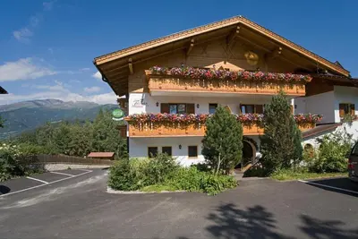 a building with flower boxes on the side of it at Hotel Thuinerwaldele in Vipiteno