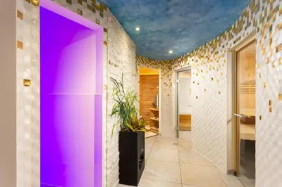a hallway with a purple door in a room at Hotel Pareda in Canazei