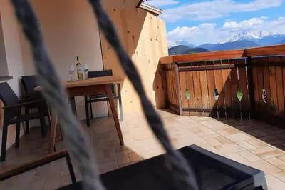 a balcony with a table and a wooden fence at Haflingerhof in San Genesio Atesino