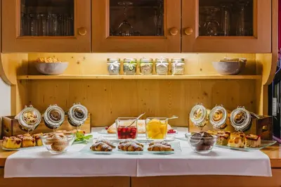 a table with food and drinks on it at Garni Hotel Belalp in Santa Cristina in Val Gardena