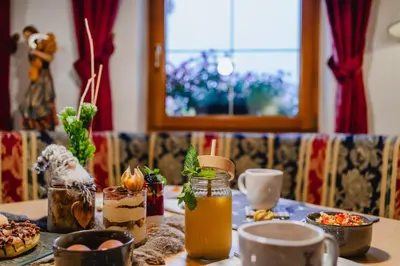 a table with food and drinks on top of it at Garni Hotel Belalp in Santa Cristina in Val Gardena