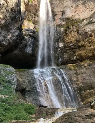 a waterfall on the side of a rocky cliff at Appartamento Cologna in Castelfondo