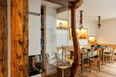 a kitchen and dining room with a table and chairs at B&B Sot l'Agner - Ospitalità Diffusa Conca Agordina in Taibon