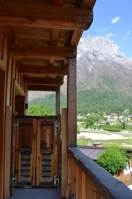 an open door of a building with a mountain in the background at B&B Sot l'Agner - Ospitalità Diffusa Conca Agordina in Taibon