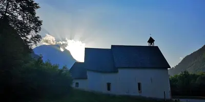 a white barn with a dog on top of it at B&B Sot l'Agner - Ospitalità Diffusa Conca Agordina in Taibon