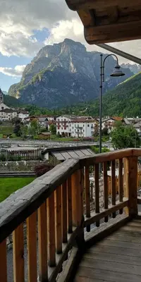 a wooden balcony with a view of a mountain at B&B Sot l'Agner - Ospitalità Diffusa Conca Agordina in Taibon