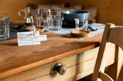 a wooden table with glasses on top of it at B&B Sot l'Agner - Ospitalità Diffusa Conca Agordina in Taibon